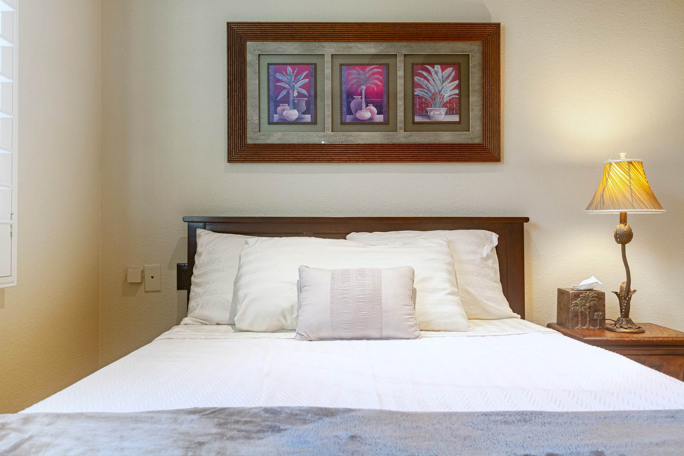Full bed in bedroom 3 under three framed prints