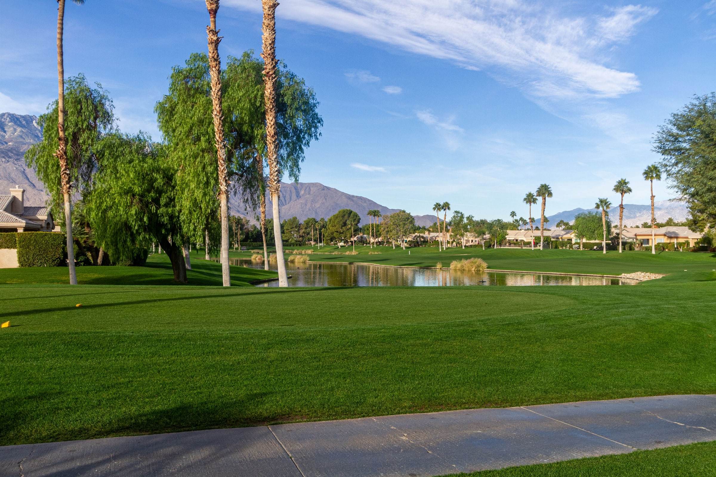 Golf-course pond and fairway with the mountains behind
