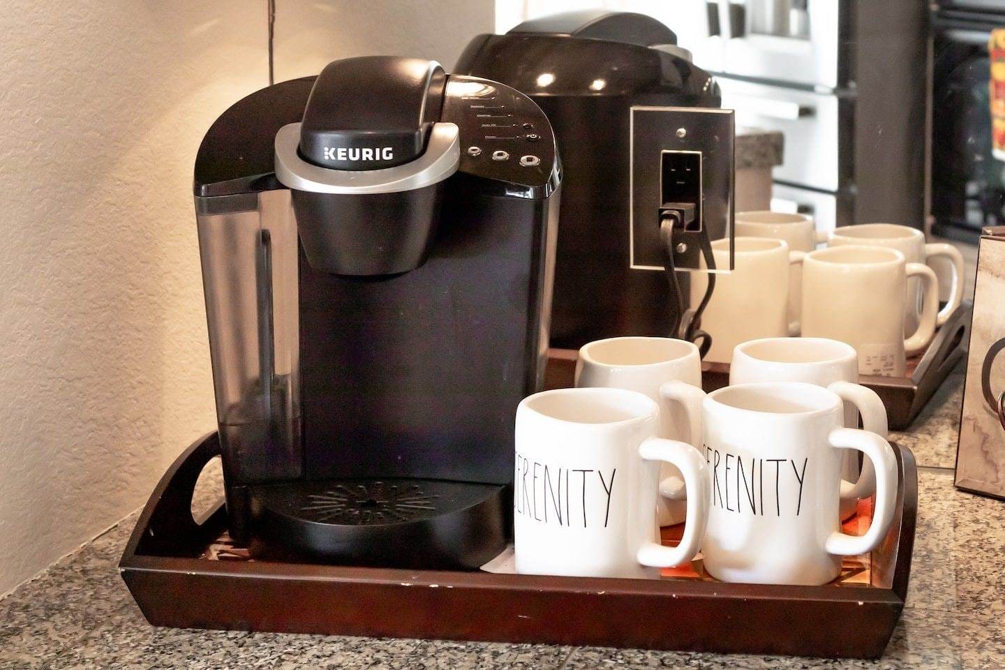 Keurig coffee maker and mugs on a tray