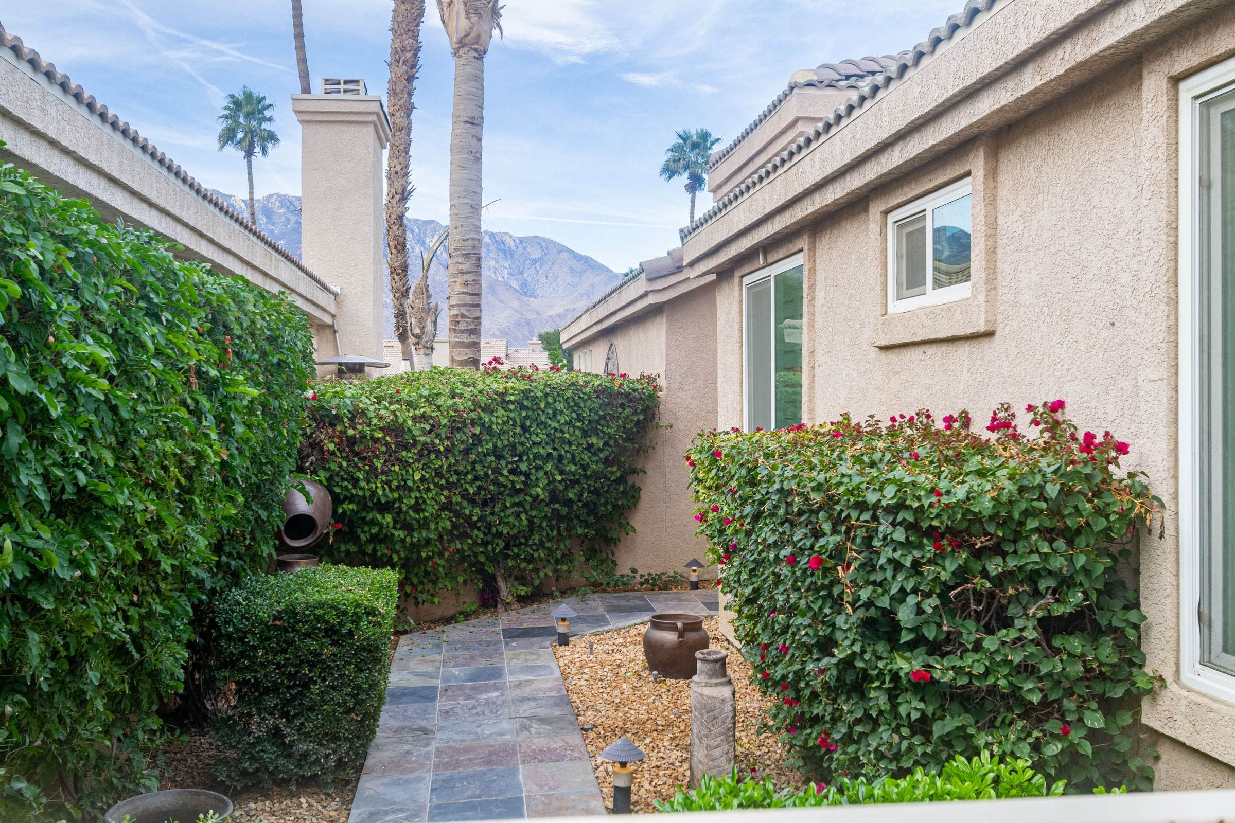 Slate path beside the house with bougainvillea and the mountains beyond