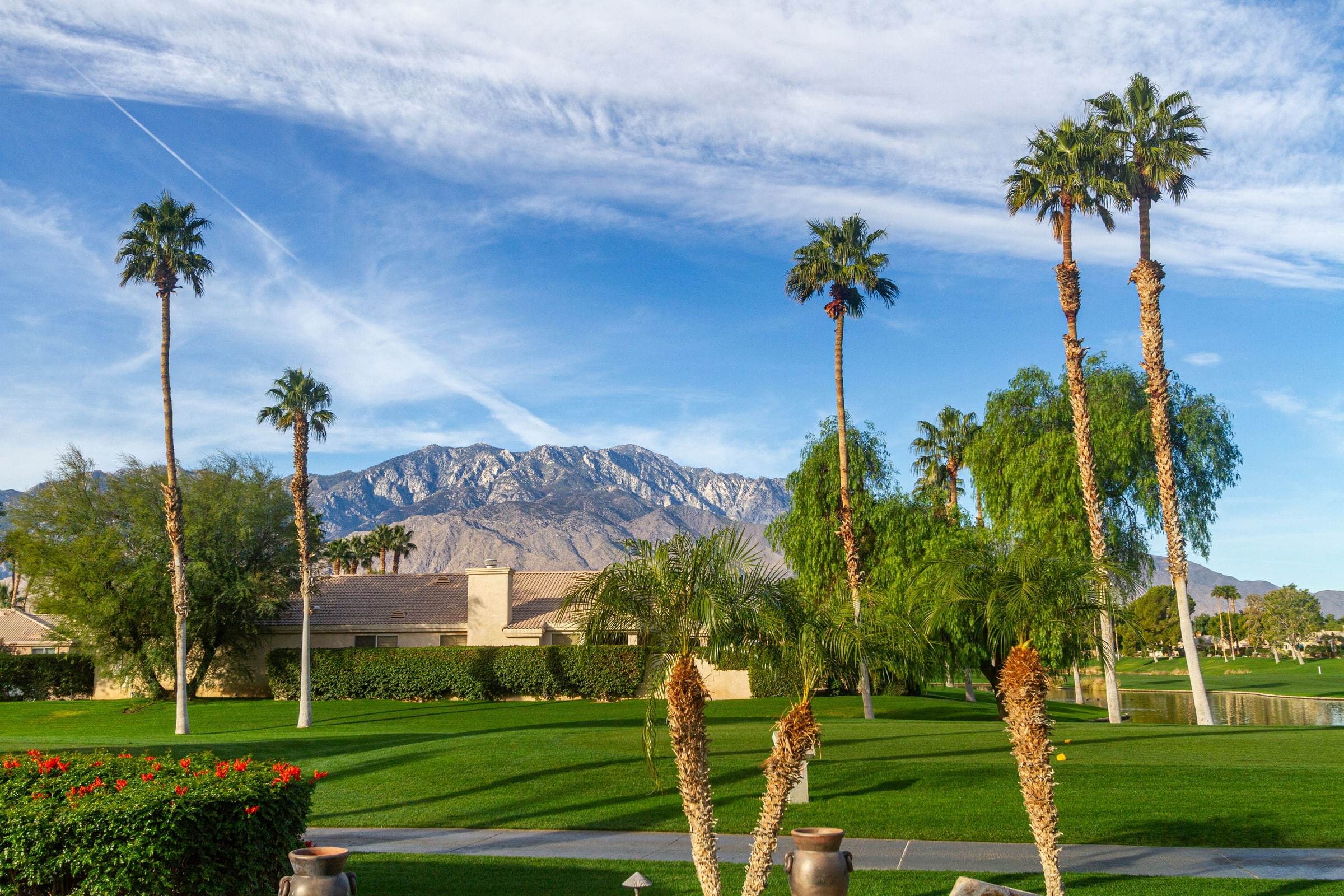 Fairway and palm trees with the mountains behind